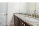 Bathroom with granite countertops, double sinks and a shower with glass doors at 7568 Marker Ave, Kissimmee, FL 34747