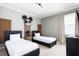 A playful bedroom design with twin beds, Mickey Mouse decor, and modern gray color scheme at 7568 Marker Ave, Kissimmee, FL 34747