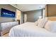 Stylish bedroom featuring a modern dresser, wall-mounted TV, and elegant decor for a comfortable living space at 7568 Marker Ave, Kissimmee, FL 34747