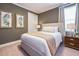 Comfortable bedroom with neutral tones, a plush bed, and stylish decor for a relaxing retreat at 7568 Marker Ave, Kissimmee, FL 34747