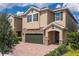 Charming two-story home with brick and stone accents, a two-car garage, and well-maintained landscaping at 7568 Marker Ave, Kissimmee, FL 34747