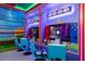 Fun-themed game room featuring gaming consoles, comfortable seating, and vibrant wall decor at 7568 Marker Ave, Kissimmee, FL 34747