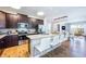 Beautiful open kitchen featuring stainless steel appliances, breakfast bar, and modern fixtures at 7568 Marker Ave, Kissimmee, FL 34747
