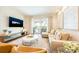Bright living room with modern entertainment center, comfortable seating, and access to outdoor patio at 7568 Marker Ave, Kissimmee, FL 34747
