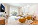 Bright living room with modern furniture, neutral tones, and a sliding glass door to the outdoor space at 7568 Marker Ave, Kissimmee, FL 34747