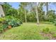 Expansive backyard with mature trees and manicured lawn, ideal for outdoor activities and relaxation at 769 Dunlap Cir, Winter Springs, FL 32708