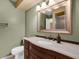Well-lit bathroom featuring a stylish vanity with a white countertop and a decorative framed mirror at 769 Dunlap Cir, Winter Springs, FL 32708