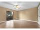 A bright bedroom with tile flooring, a ceiling fan, and a sliding glass door leading to the outside at 769 Dunlap Cir, Winter Springs, FL 32708