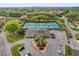 Aerial view showcasing community tennis courts, clubhouse, and parking area, ideal for active living at 769 Dunlap Cir, Winter Springs, FL 32708