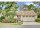 Charming single-story home featuring a two-car garage, mature landscaping, and a welcoming front entrance at 769 Dunlap Cir, Winter Springs, FL 32708