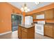 Bright kitchen featuring granite countertops, an island, tile floors, and access to a screened patio at 769 Dunlap Cir, Winter Springs, FL 32708