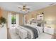 Comfortable main bedroom with a ceiling fan, sliding glass doors, and stylish decor at 769 Dunlap Cir, Winter Springs, FL 32708