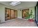 A covered patio showcasing a tiled floor, a skylight, and sliding glass doors leading to the interior at 769 Dunlap Cir, Winter Springs, FL 32708