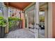 A charming balcony with a wrought iron railing offers views through french doors of the bright living area at 911 N Orange Ave # 104, Orlando, FL 32801