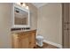 Bathroom features an ornate vanity with a marble countertop and framed mirror at 911 N Orange Ave # 104, Orlando, FL 32801