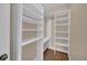 A well-organized walk-in closet featuring ample shelving, providing lots of storage space at 911 N Orange Ave # 104, Orlando, FL 32801