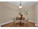Cozy dining area with a round table, four chairs, and modern lighting with wood floors at 911 N Orange Ave # 104, Orlando, FL 32801
