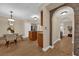 Open-concept dining area with wood tile flooring, modern lighting, and views of the kitchen and living room at 911 N Orange Ave # 104, Orlando, FL 32801