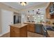 Bright kitchen with wood cabinets, granite countertops, stainless steel appliances and views of the living room at 911 N Orange Ave # 104, Orlando, FL 32801