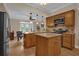 Well-equipped kitchen with wood cabinetry, granite countertops, modern appliances, and a central island at 911 N Orange Ave # 104, Orlando, FL 32801