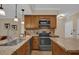 Modern kitchen with wood cabinets, granite countertops, stainless steel appliances and tile backsplash at 911 N Orange Ave # 104, Orlando, FL 32801