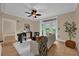 Bright living room with wood flooring, a ceiling fan, and large doors opening to the outside area at 911 N Orange Ave # 104, Orlando, FL 32801