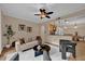 Cozy living room features neutral tones, a modern ceiling fan, stylish furniture and view into the kitchen at 911 N Orange Ave # 104, Orlando, FL 32801