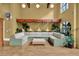 Open lounge area with a large sectional sofa, hardwood floors, plants, and a decorative canopy feature above at 911 N Orange Ave # 104, Orlando, FL 32801