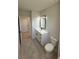 Bathroom with modern vanity, fixtures and ceramic tile at 917 Swallow St, Deltona, FL 32725