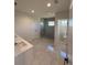 Bright bathroom showcasing a double vanity, walk-in shower, and separate toilet room at 917 Swallow St, Deltona, FL 32725