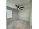 Bright bedroom with grey tile flooring, a ceiling fan and a window for natural light at 917 Swallow St, Deltona, FL 32725