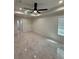 Spacious bedroom with tray ceiling, fan, recessed lights, and tile flooring at 917 Swallow St, Deltona, FL 32725