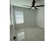 Bedroom features ceramic tile floor, ceiling fan, and a window at 917 Swallow St, Deltona, FL 32725