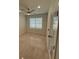 Clean, bright bedroom with modern ceiling fan and ample natural light from a large window at 917 Swallow St, Deltona, FL 32725