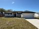 Inviting single-story home with a manicured front lawn and an attached garage at 917 Swallow St, Deltona, FL 32725