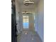 Bright and airy foyer with glossy tiled floors and modern light fixture at 917 Swallow St, Deltona, FL 32725