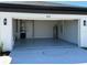 View of the garage featuring painted floors, overhead lighting, and garage door at 917 Swallow St, Deltona, FL 32725