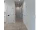 Ceramic tile hallway with white walls and doors at 917 Swallow St, Deltona, FL 32725
