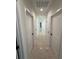 Hallway with grey tile flooring and white doors leading to the different rooms of the house at 917 Swallow St, Deltona, FL 32725
