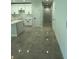 Hallway with grey tile flooring and white doors leading to the different rooms of the house at 917 Swallow St, Deltona, FL 32725