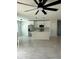 Open floor plan showcasing a modern kitchen with island, stainless appliances, and sleek pendant lighting at 917 Swallow St, Deltona, FL 32725