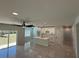Bright living room featuring an open floor plan, island kitchen, and sliding glass doors to the yard at 917 Swallow St, Deltona, FL 32725