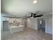 Spacious open-concept living and kitchen area with gleaming tile floors and modern finishes at 917 Swallow St, Deltona, FL 32725