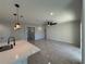 Open concept living room view from kitchen with island, modern fixtures and an airy feel at 917 Swallow St, Deltona, FL 32725