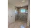 Bathroom with seamless glass shower enclosure and gray stone tile at 917 Swallow St, Deltona, FL 32725