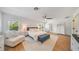 Bright main bedroom features a ceiling fan, white walls, wood floors, and large rug at 10236 Chorlton Cir, Orlando, FL 32832