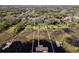 Aerial view of a lakefront property with boat house and dock, outlined in white against a vibrant backdrop at 10411 Hart Branch Cir, Orlando, FL 32832
