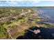 High angle aerial view of a boat house extending into the lake and the neighborhood homes along the waterfront at 10411 Hart Branch Cir, Orlando, FL 32832