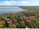 Aerial view of waterfront homes bordering the lake with private docks in a wooded landscape at 10411 Hart Branch Cir, Orlando, FL 32832