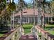 Scenic backyard view featuring a screened-in patio, lush green lawn, and mature trees, creating a serene retreat at 10411 Hart Branch Cir, Orlando, FL 32832
